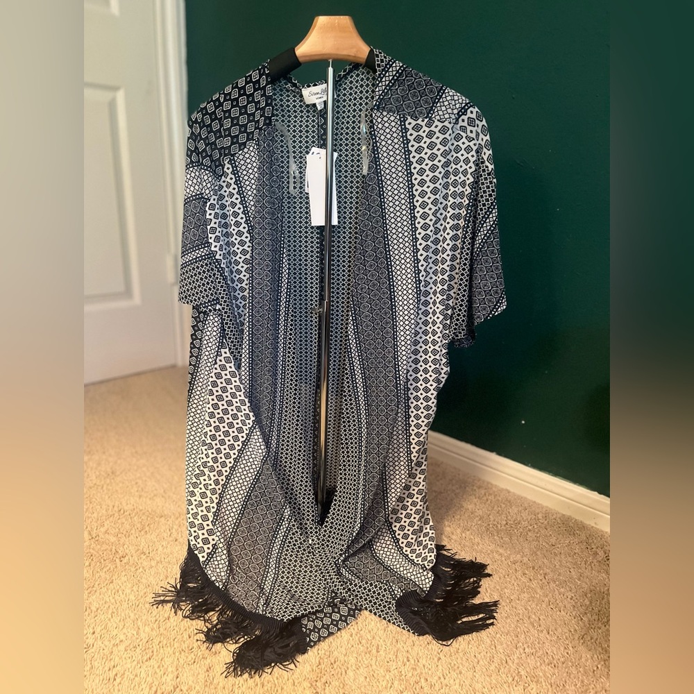 Nice shrug or swimsuit coverup. Never worn
